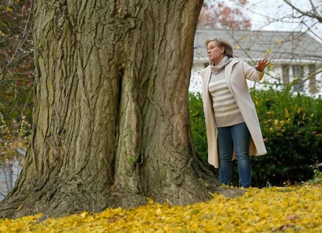Margaret Skinner stands next to a ginkgo tree in front of her grandparents' home in Akron, Ohio.
