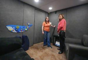 Elena Bell and Alice Luse inspect tactile wall activities inside the Akron Zoo Guest Comfort Station.